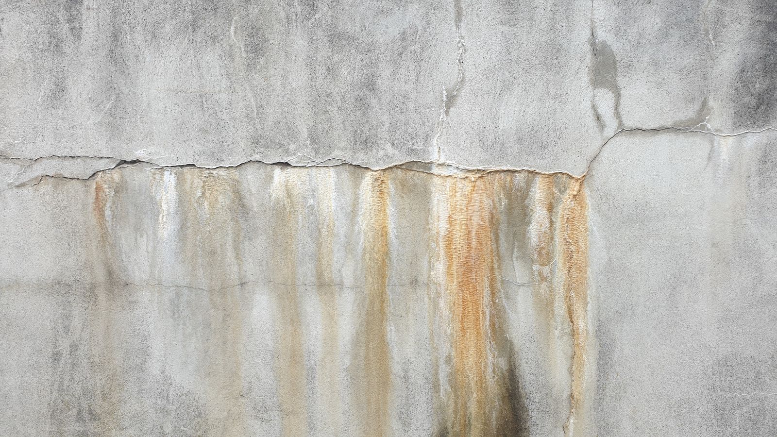 Concrete wall with water staining and cracking