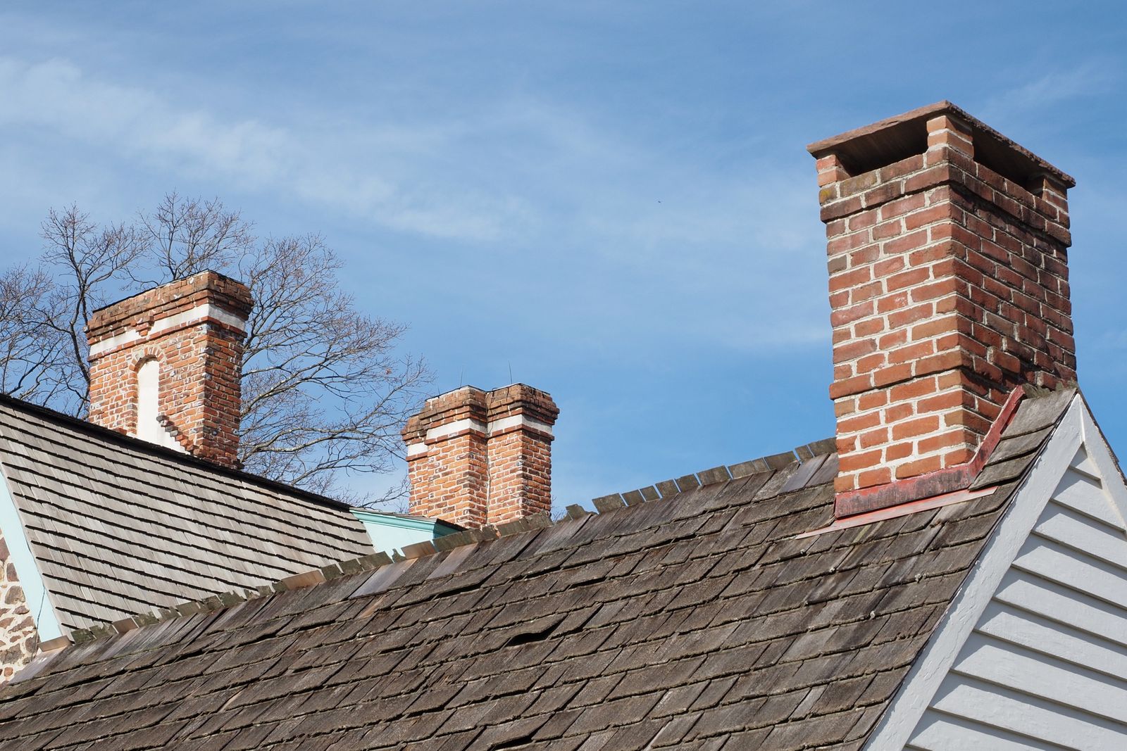 Brick chimneys on a residential rooftop