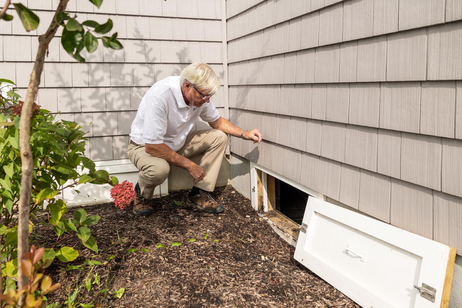Home inspection at a crawl space entrance