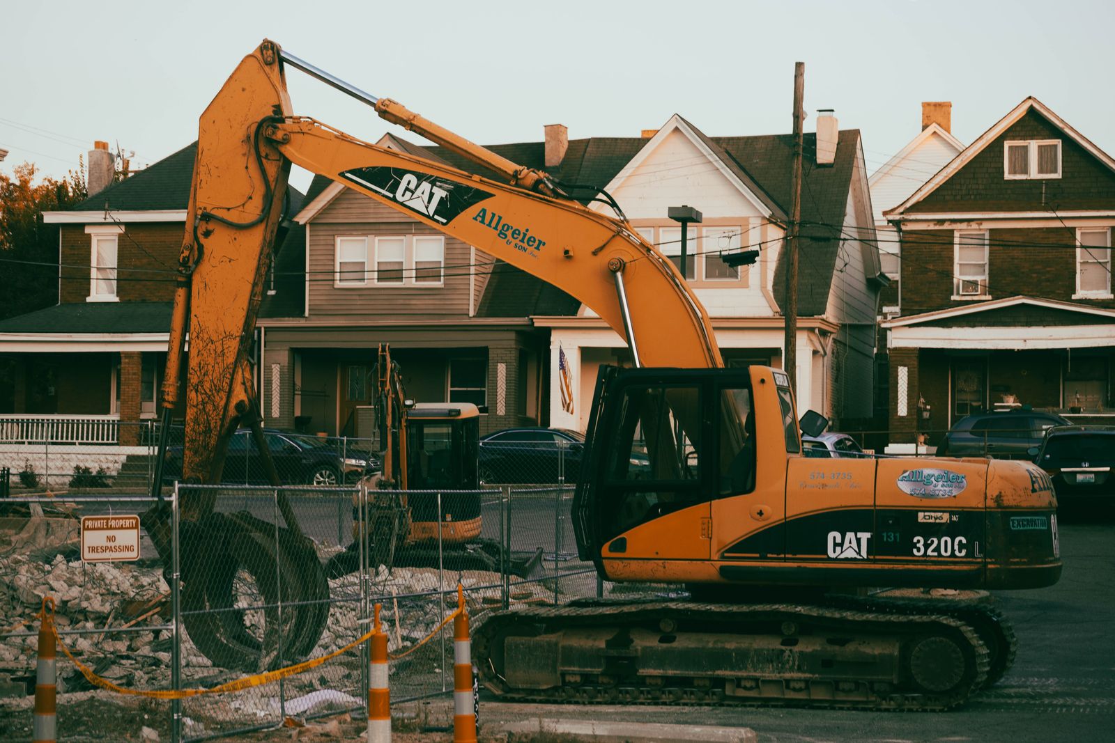 Excavator working on a site in a residential neighborhood